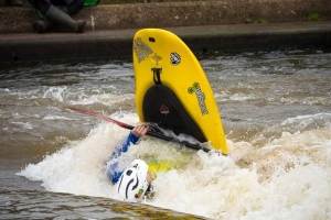 Staff member henry in a whitewater freestyle kayak