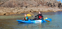 Child paddling with parent on the Feelfree Juntos