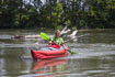 paddling along a river in the Gumotex Framura inflatable touring kayak