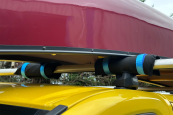 4 pack of canoe pads holding a canoe on a yellow van