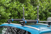 enigma canoes pads next to kayak upright on a roofrack