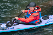 A sea kayaker wearing the Palm Bora Mens Suit in a P&H Volan