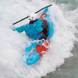 Kayaker in the peak deluxe 2.5L evo in rough water paddling a pyranha scorch